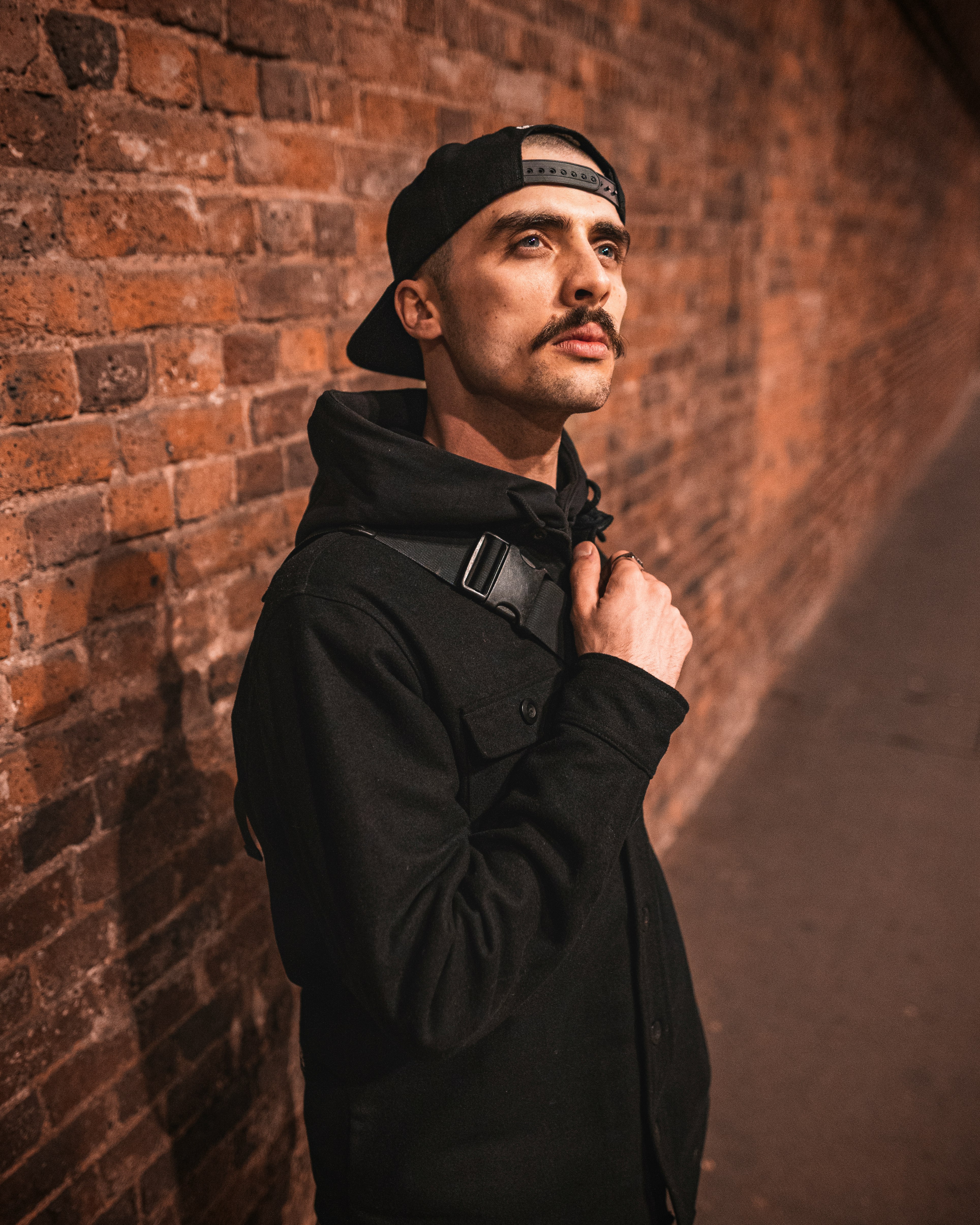 man in black coat and black cap